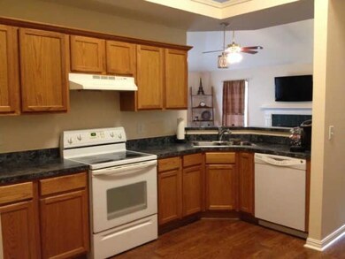 KITCHEN WITH LOTS OF OAK CABINETS, BREAKFAST BAR  [STOOLS NOT INCLUDED]. REFRIGERATOR NEGOTIABLE!