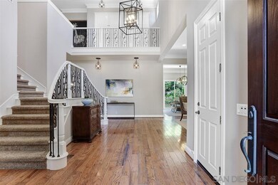 2-Story Grand Foyer with elegant Wrought Iron Chan