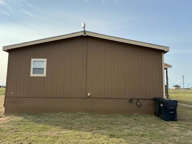 View of side of home featuring a lawn and crawl s