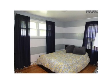 Bedroom 2 on main floor with hardwood floors.