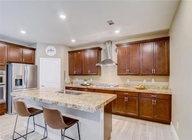 Kitchen featuring stainless steel fridge with ice