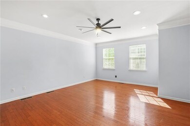Spare room with ceiling fan, ornamental molding, hardwood / wood-style floors, baseboards, and recessed lighting