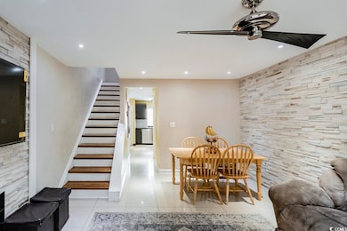 Dining area with light tile patterned floors, rece