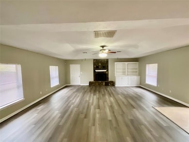 Unfurnished living room with hardwood / wood-style