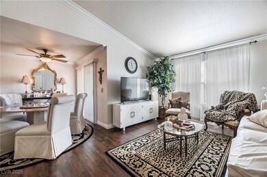Living room with ornamental molding, wood finished