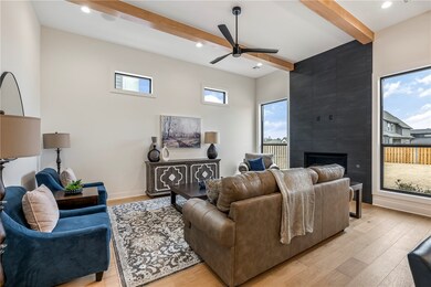 The living room boasts a sleek gas linear fireplac