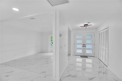 View leaving Kitchen towards front door and Foyer.