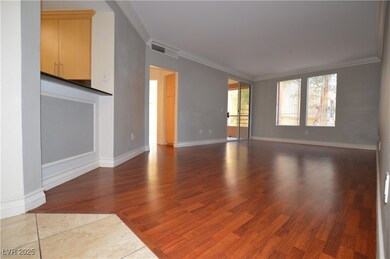 Unfurnished living room featuring baseboards, wood