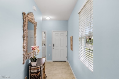 Doorway to outside with tile patterned floors and washer / clothes dryer