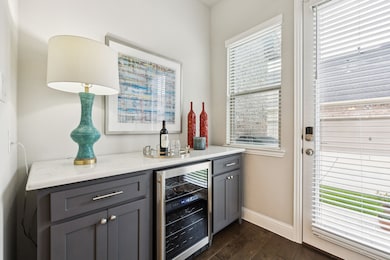 Custom cabinetry wine-butler's pantry complete with two-zone wine fridge.