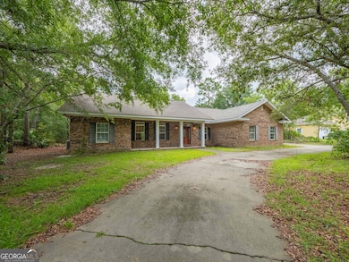 Shaded driveway leads to a peaceful front entrance with plenty of curb appeal.