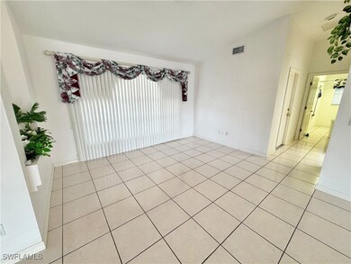 Tiled empty room with vaulted ceiling