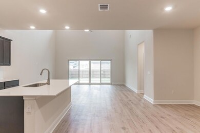 Kitchen featuring a sink, open floor plan, light 