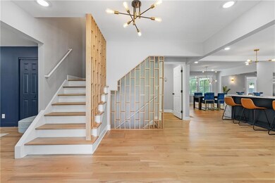 Stairs with baseboards, wood finished floors, rece