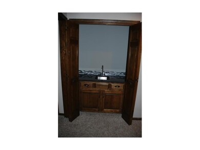 Wet bar in great room, granite top, glass tiled ba