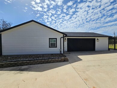 Single story home with an attached garage, concre