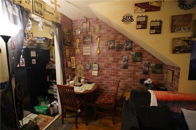 Dining area featuring brick wall and hardwood / wood-style flooring