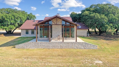 Rear view of property with a patio and a yard
