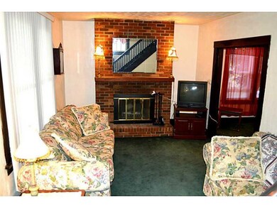 Living Room. Living room features brick fireplace 