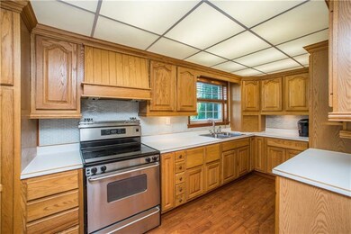 The nicely sized kitchen has loads of cabinets and