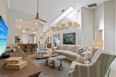 Living room with sink and high vaulted ceiling