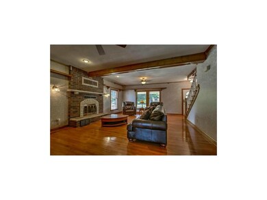 Great Room has large brick fireplace and large win