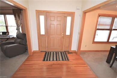 Welcoming Foyer with hardwood floors