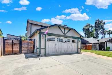 This home as a spacious inner corner lot with extended space for parking on the left side of the parcel.  There is also paved RV parking with hookup on the right, secured behind a customized gate.  Note the stamped contrete pathway that continues on 