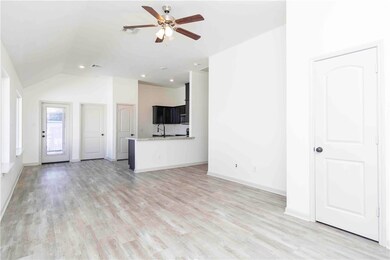 Unfurnished living room featuring light wood-type flooring, vaulted ceiling, a ceiling fan, and recessed lighting
