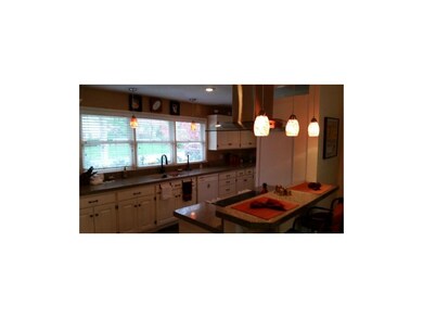 Granite counters, pendant lighting and breakfast b
