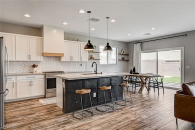 Kitchen with stainless steel gas stove, light coun