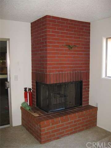 beautiful corner fireplace made of brick w/gas sta