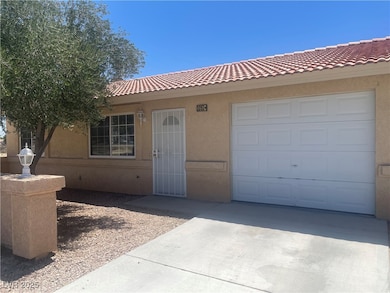 View of front of home with concrete driveway, stuc