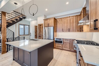Open kitchen with quartz and Viking applances.