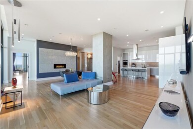 The open floor plan, framed by floor-to-ceiling windows, delivers sweeping, unobstructed views from every room.