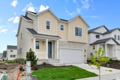 View of front of property featuring board and batten siding, driveway, an attached garage, stone siding, and a front lawn