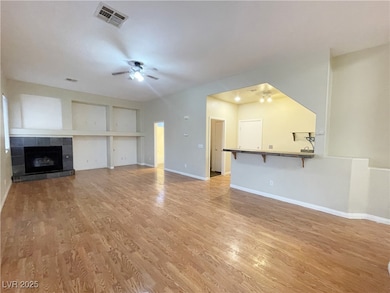 Unfurnished living room with a tile fireplace, a c