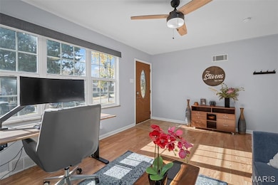Office area featuring ceiling fan and wood finished floors