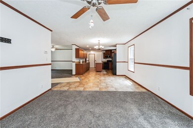 Unfurnished living room with a ceiling fan, a chan