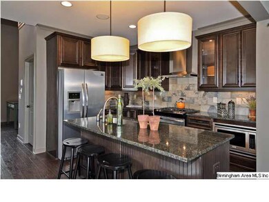 View of the kitchen with rich expresso cabinets, g