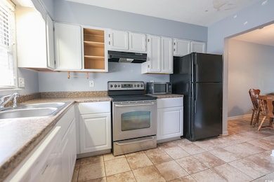 Kitchen featuring under cabinet range hood, stainl