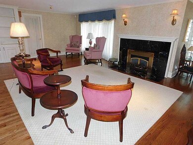 Living Room. bow window, built-in bookcase and gas