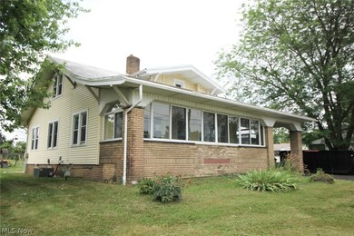 View of front of house featuring a front lawn and central AC unit