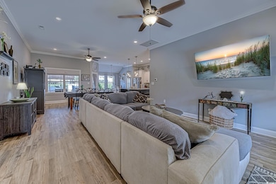 Living area with a ceiling fan, baseboards, light 