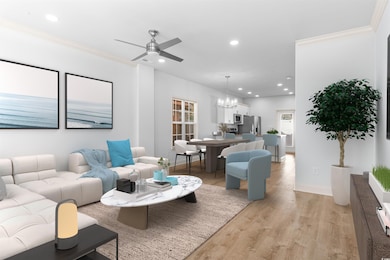 Living room featuring crown molding, ceiling fan w