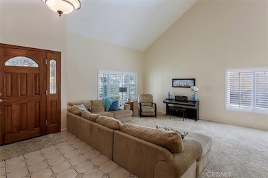 WIDE ENTRYWAY WITH COAT CLOSET TO THE RIGHT OF FRONT DOOR. STEP DOWN LIVING ROOM WITH VALUTED CEILINGS & PLANTATION SHUTTERS