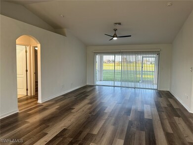 Spare room with ceiling fan, dark wood-type floori
