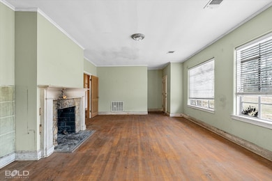 Unfurnished living room with ornamental molding, b