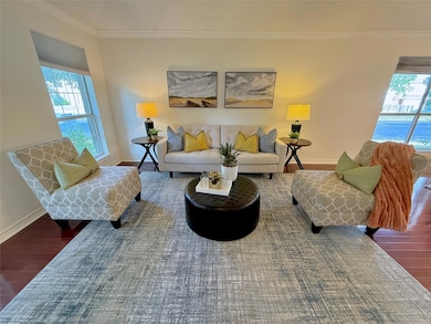 Living room featuring wood finished floors, baseb