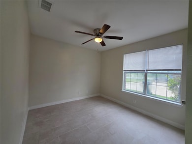 Empty room with ceiling fan, baseboards, and ligh